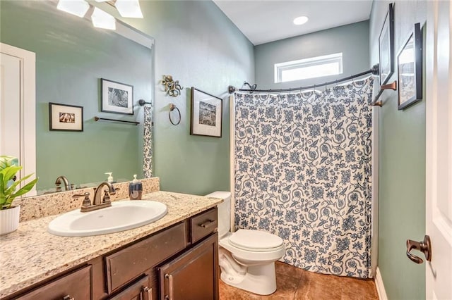 bathroom featuring tile patterned flooring, vanity, curtained shower, and toilet