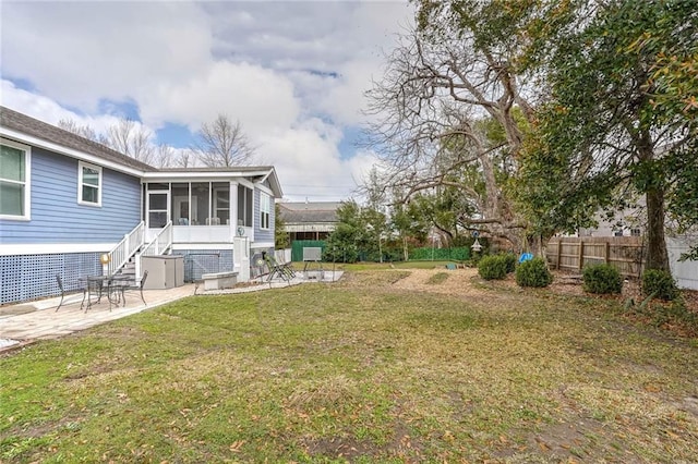 view of yard featuring a patio and a sunroom