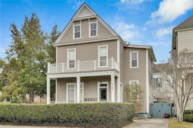 view of front of house featuring a balcony and covered porch