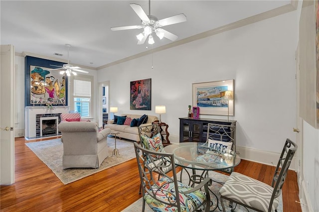 dining area with crown molding, ceiling fan, and light wood-type flooring