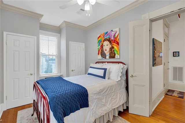 bedroom with crown molding, ceiling fan, and light wood-type flooring