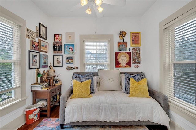 bedroom with multiple windows, hardwood / wood-style floors, and ceiling fan