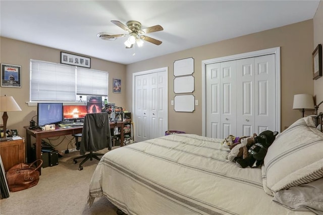 bedroom with multiple closets, ceiling fan, and carpet floors