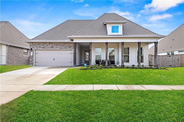 view of front of home with a porch, a garage, and a front yard