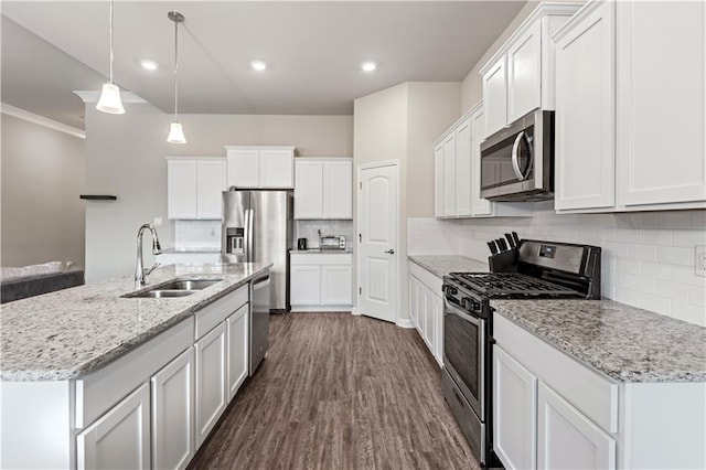 kitchen featuring a kitchen island with sink, sink, stainless steel appliances, and white cabinets