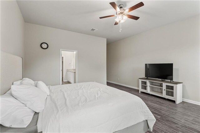 bedroom with ceiling fan, ensuite bathroom, and dark hardwood / wood-style flooring