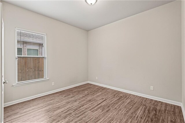 unfurnished room featuring hardwood / wood-style flooring