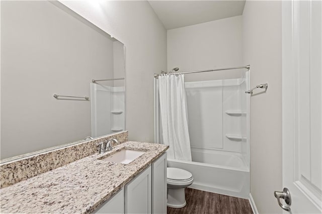 full bathroom featuring hardwood / wood-style flooring, vanity, toilet, and shower / tub combo