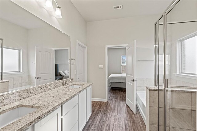 bathroom with vanity, hardwood / wood-style floors, and shower with separate bathtub