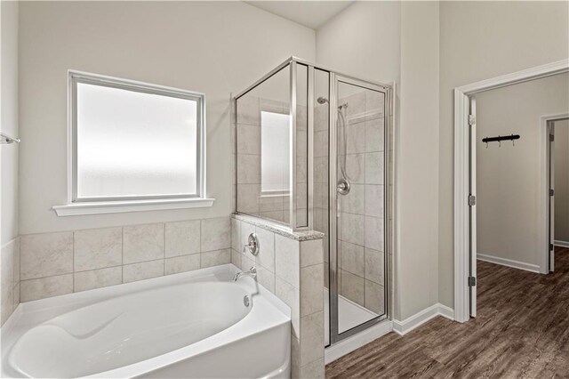 bathroom featuring shower with separate bathtub and hardwood / wood-style floors