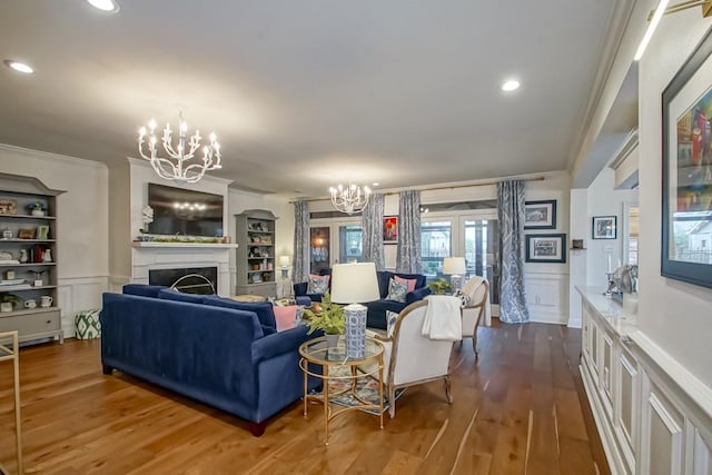 living room featuring crown molding, dark hardwood / wood-style floors, and a chandelier