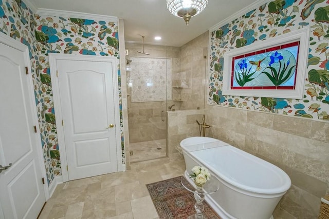 bathroom with crown molding, separate shower and tub, and tile walls