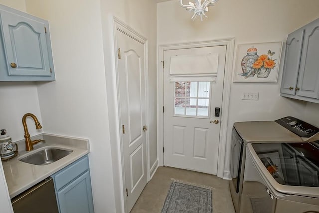 laundry room featuring cabinets, washing machine and dryer, and sink