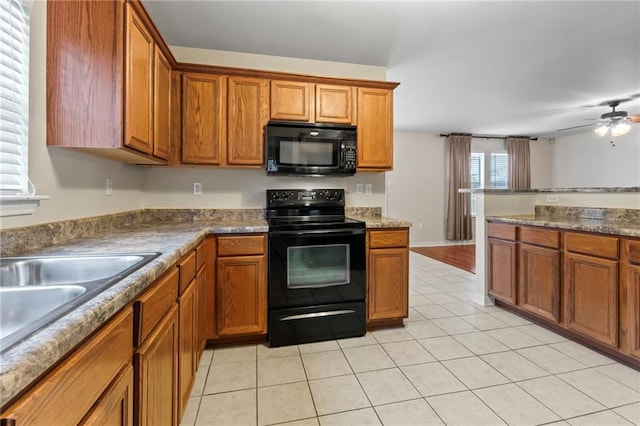 kitchen featuring sink, light tile patterned floors, ceiling fan, and black appliances