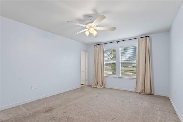 carpeted spare room featuring ceiling fan