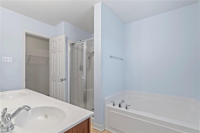 bathroom featuring vanity and independent shower and bath