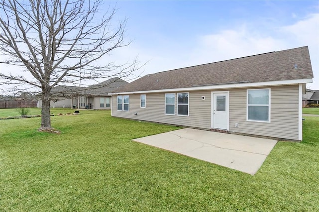 rear view of property with a lawn and a patio area