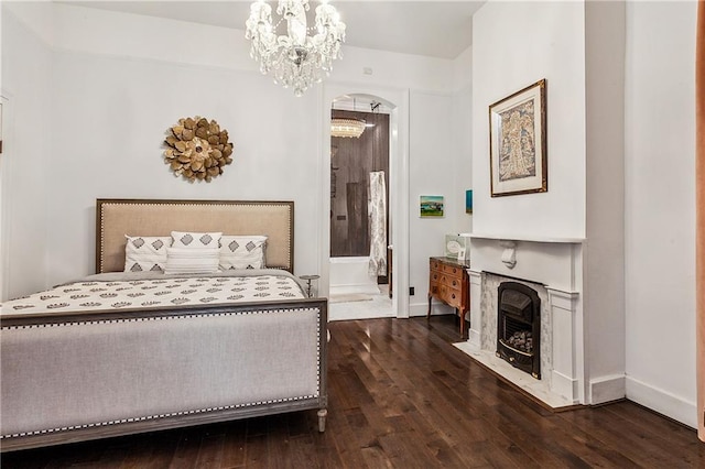 bedroom featuring dark wood-type flooring and an inviting chandelier