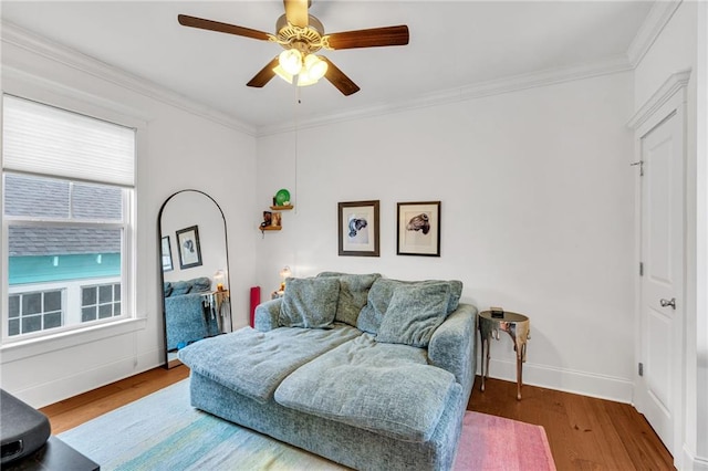 living room with crown molding, ceiling fan, and wood-type flooring