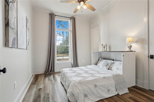 bedroom featuring crown molding, hardwood / wood-style floors, and ceiling fan