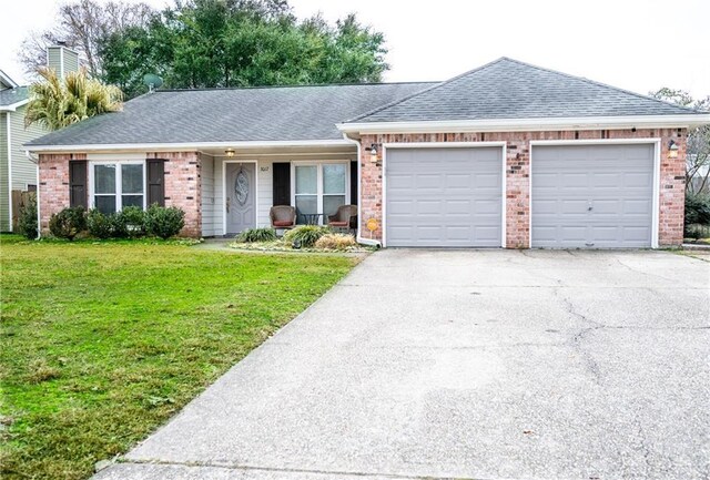 single story home with a garage and a front lawn