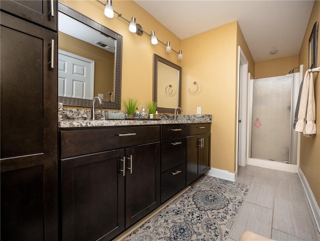 bathroom with vanity and a shower with shower door