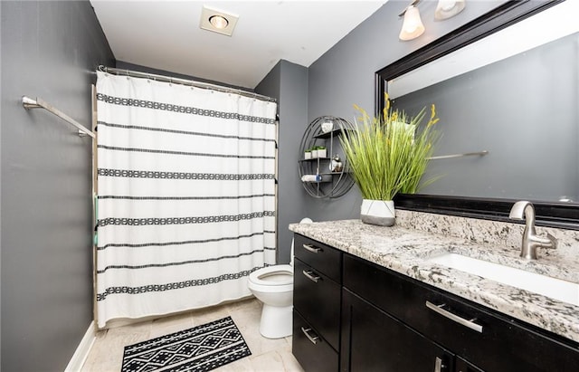 bathroom with vanity, tile patterned floors, and toilet