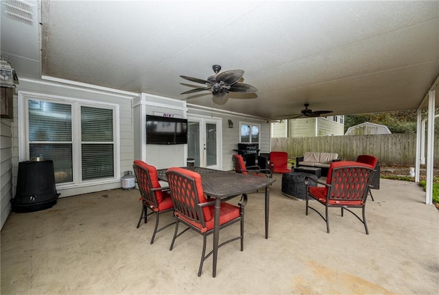 view of patio / terrace featuring area for grilling, an outdoor living space with a fire pit, and ceiling fan