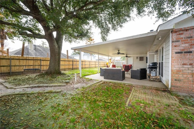 view of yard featuring outdoor lounge area, a patio, and ceiling fan