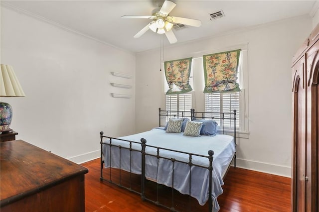 bedroom featuring ornamental molding, dark hardwood / wood-style floors, and ceiling fan