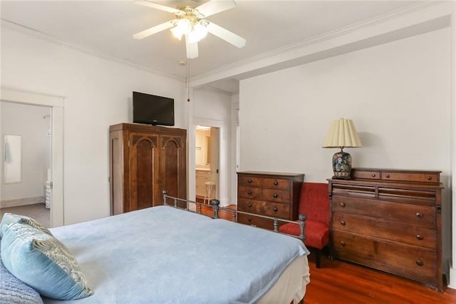 bedroom with dark wood-type flooring, ceiling fan, ornamental molding, and connected bathroom