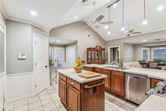 kitchen with pendant lighting, sink, dishwasher, a center island, and ornamental molding