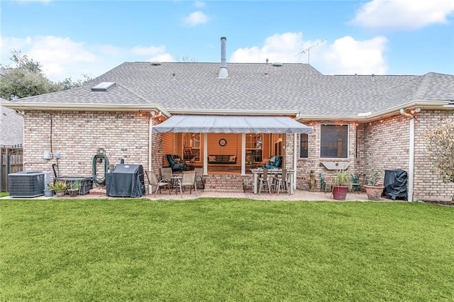 back of property featuring central AC unit, a yard, and a patio