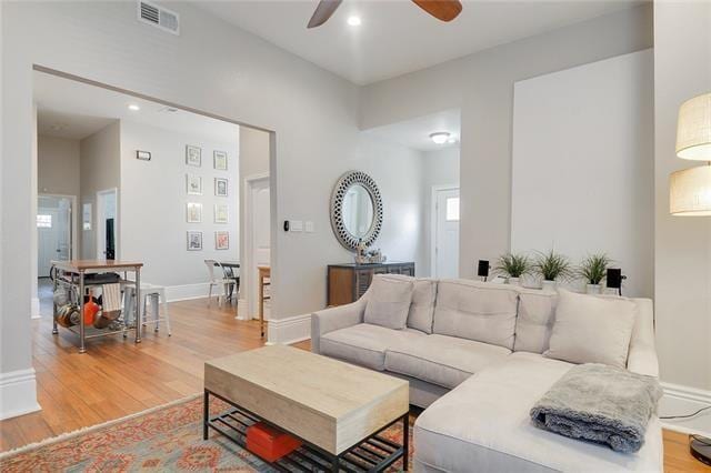 living room featuring ceiling fan and light wood-type flooring