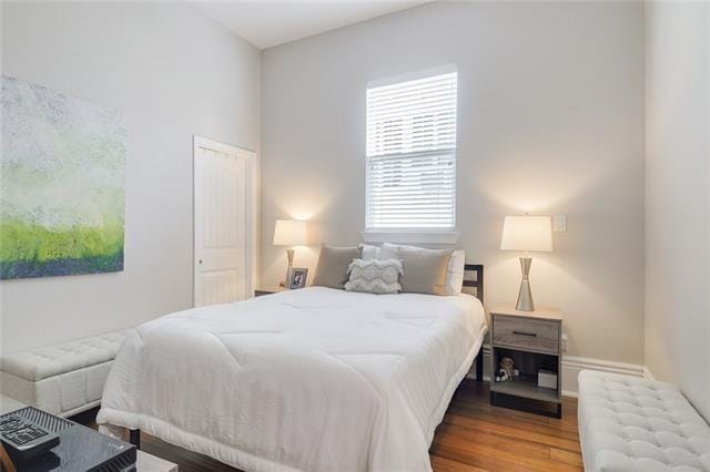 bedroom featuring radiator and hardwood / wood-style floors