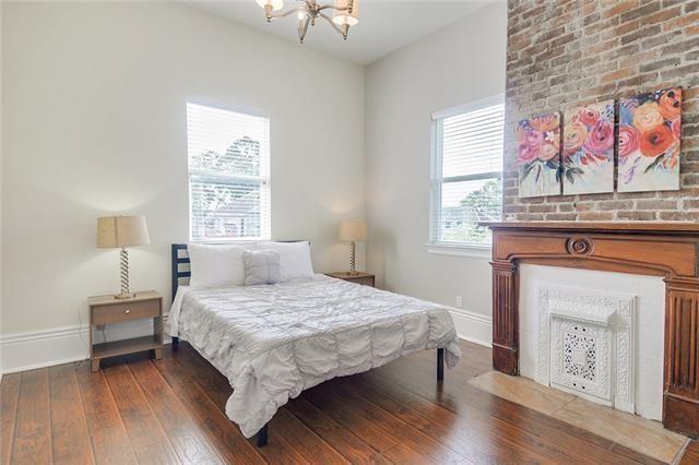 bedroom with an inviting chandelier and dark hardwood / wood-style floors