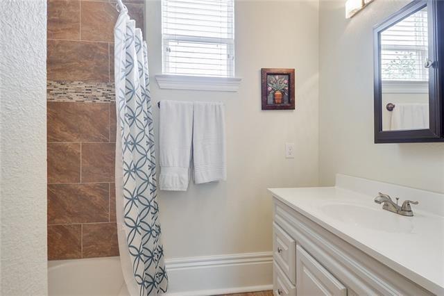 bathroom with vanity and shower / bathtub combination with curtain