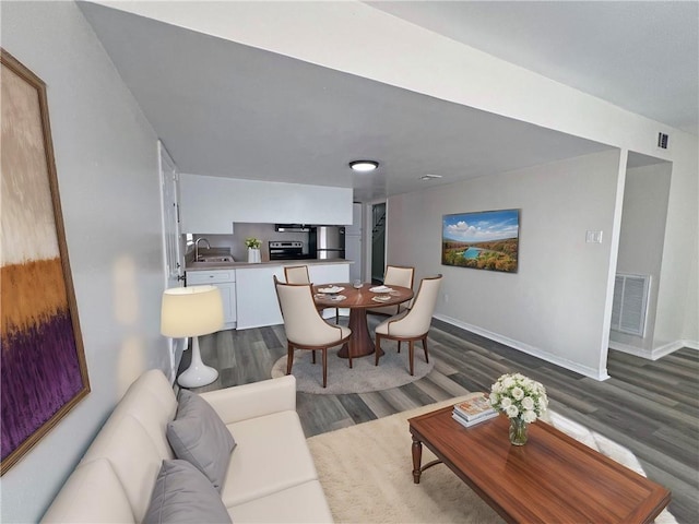 living room with dark hardwood / wood-style flooring and sink