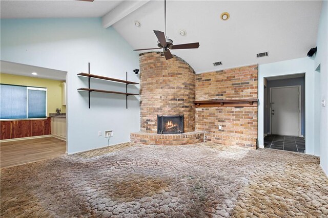 unfurnished living room with dark wood-type flooring, ceiling fan, high vaulted ceiling, a fireplace, and beamed ceiling