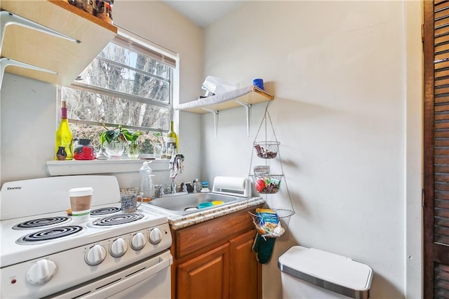 kitchen featuring white electric range oven and sink