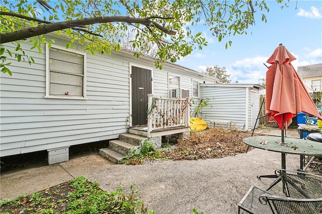 exterior space with a patio and a storage shed