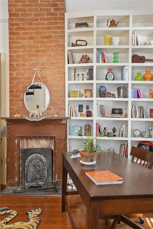 living area with a large fireplace and wood-type flooring