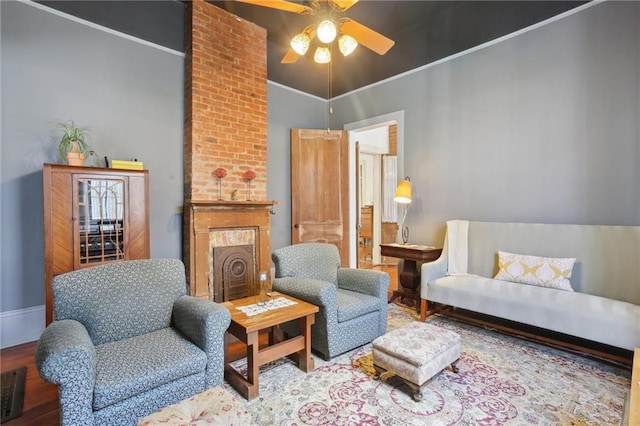 sitting room with ceiling fan, ornamental molding, and hardwood / wood-style floors