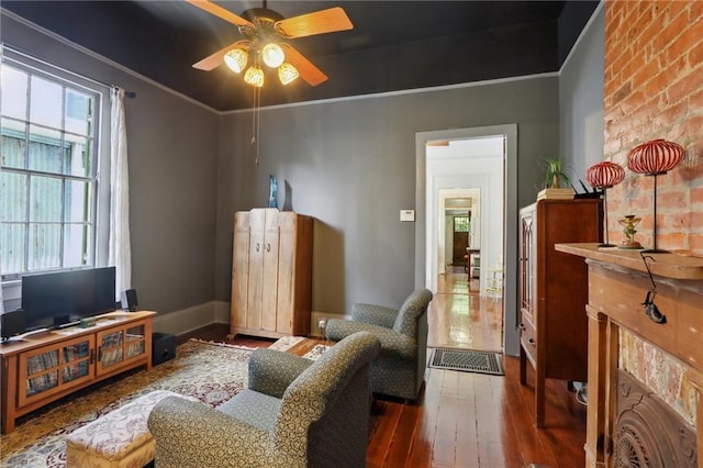 sitting room featuring crown molding, ceiling fan, and dark hardwood / wood-style floors