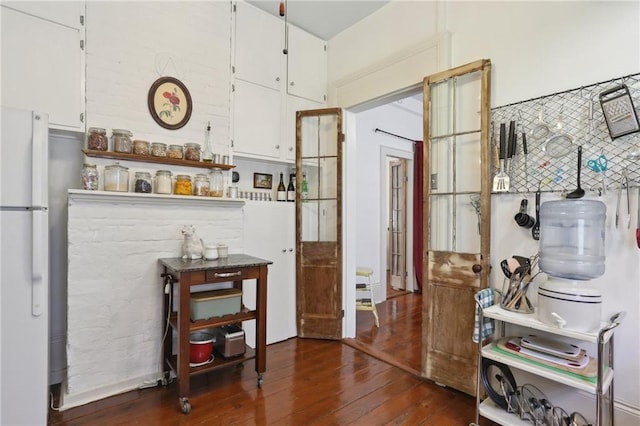 interior space with white cabinetry, dark hardwood / wood-style flooring, and white refrigerator