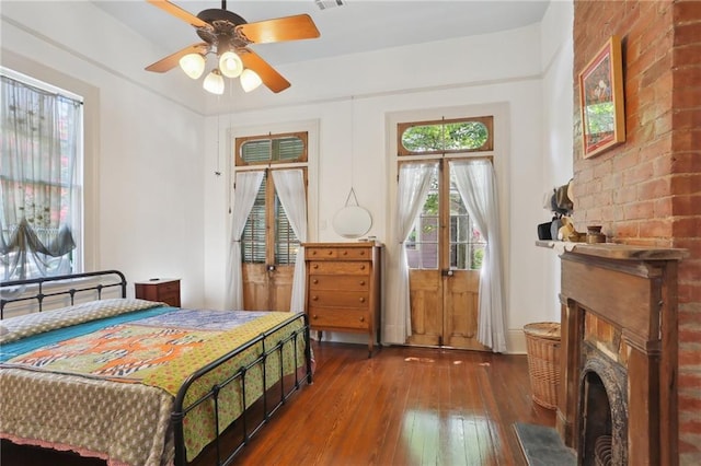 bedroom with dark hardwood / wood-style floors and ceiling fan