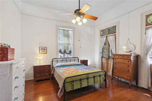 bedroom featuring ceiling fan and dark hardwood / wood-style floors