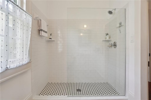 bathroom with tiled shower