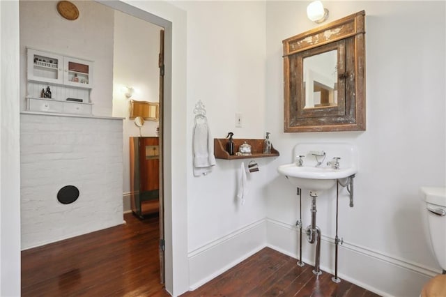 bathroom featuring hardwood / wood-style floors, sink, and toilet