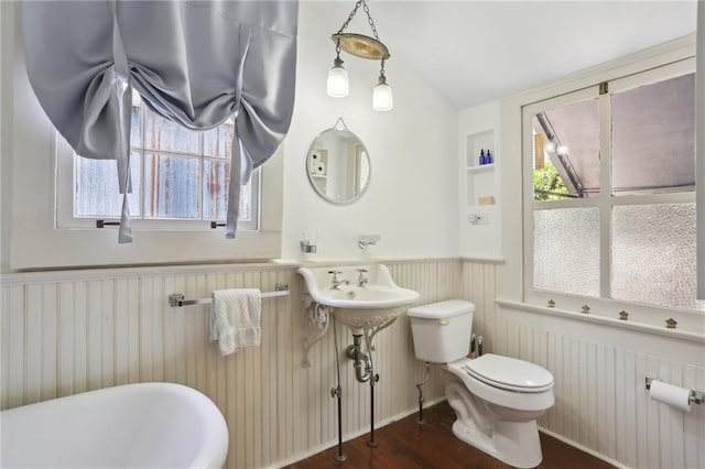 bathroom with hardwood / wood-style flooring, plenty of natural light, and toilet